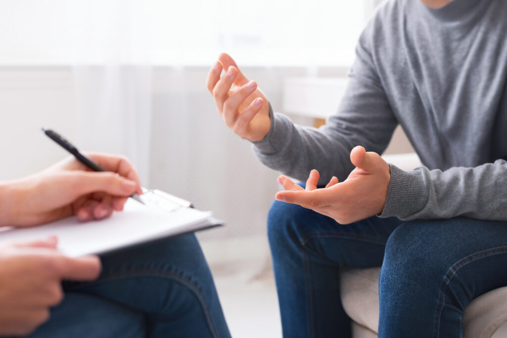 Psychotherapist writing notes, assessing patient's health and giving diagnosis